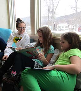 three girl students reading